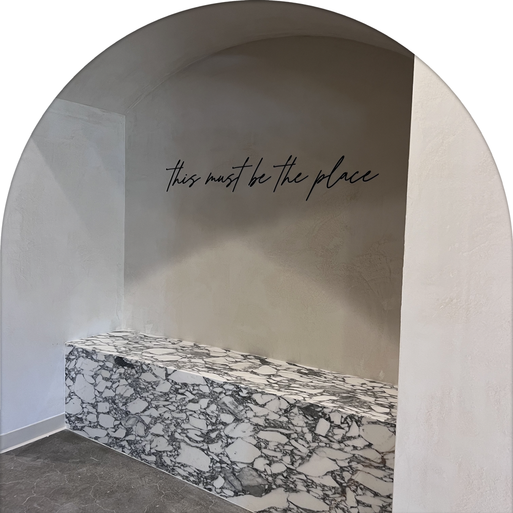 be kind studio corner with special tile with 'this must be the place' text on the wall